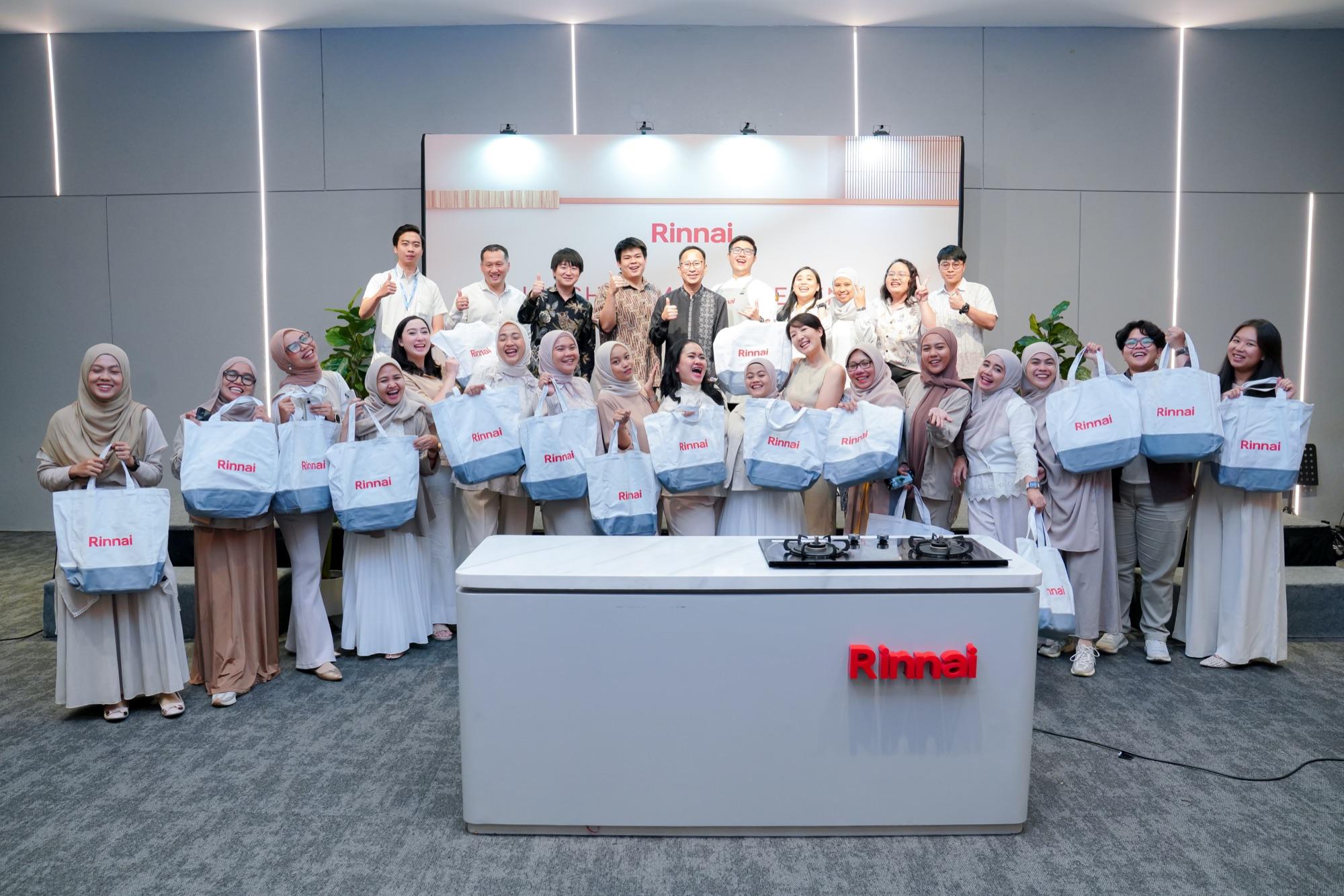 The Rinnai Kitchen Master event in Jakarta: guests holding Rinnai tote bags around a demonstration hob, under a Rinnai backdrop.