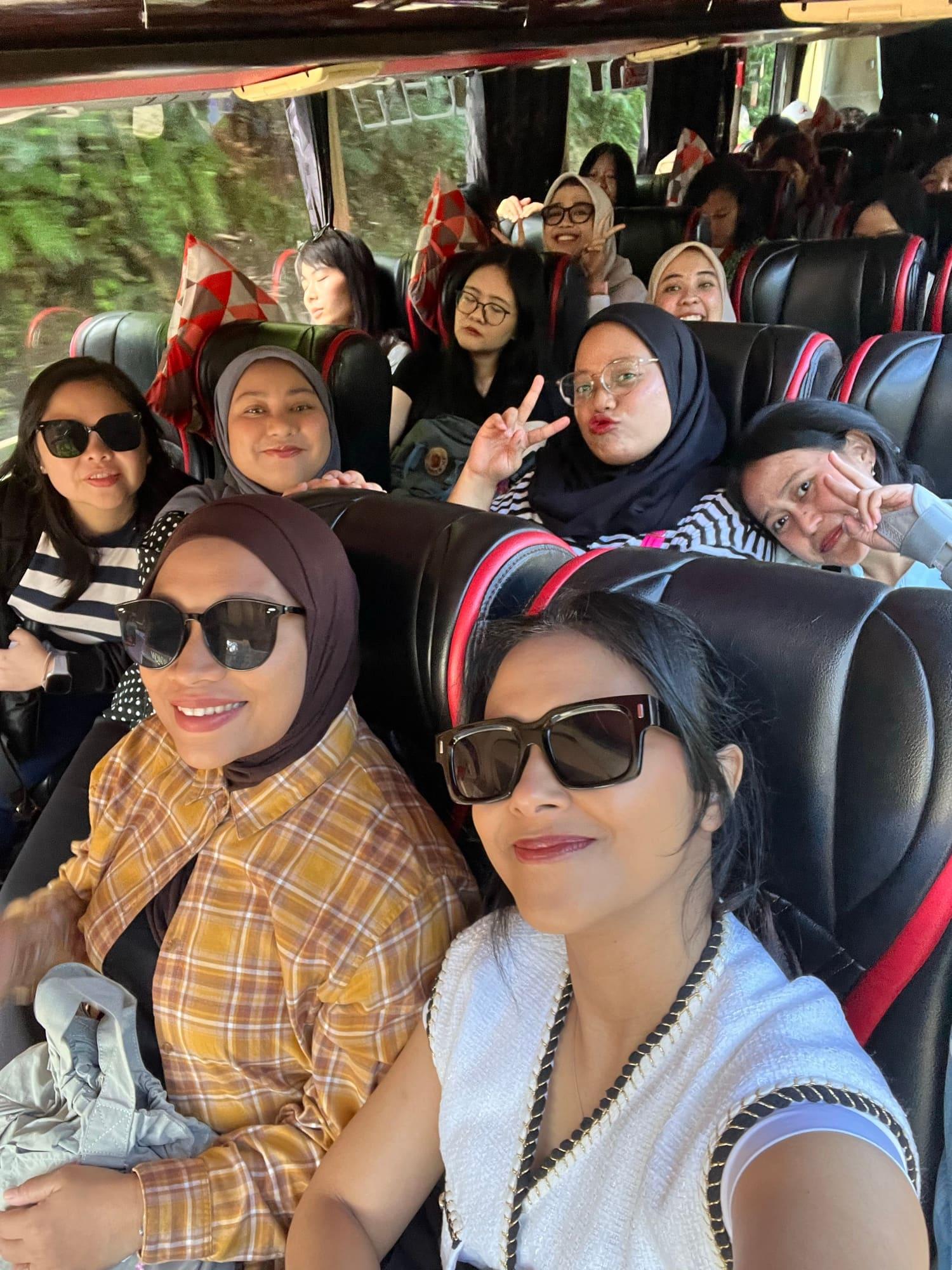 Colleagues turned around in their coach seats, waving and pulling faces on the drive out to a company retreat.